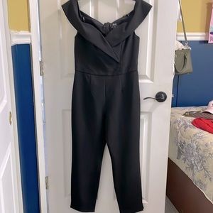 Bardot black jumpsuit. Fabric textured like snake.